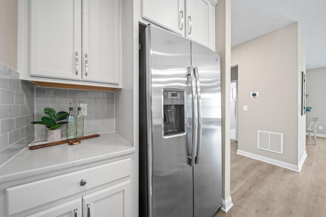 5508 Camlin Pl W Unit 48, Westerville, OH 43081 - kitchen with stainless steel fridge with ice dispenser, backsplash, white cabinets, light wood-type flooring, and light stone counters
