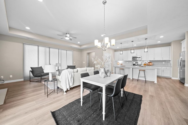 5508 Camlin Pl W Unit 48, Westerville, OH 43081 - dining room with a tray ceiling, recessed lighting, light wood-type flooring, ceiling fan, and a chandelier