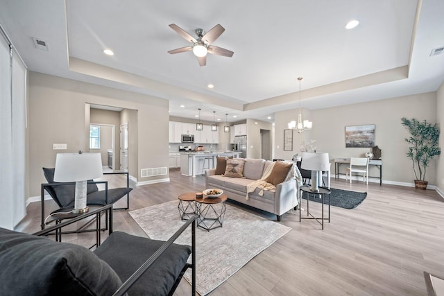 5508 Camlin Pl W Unit 48, Westerville, OH 43081 - living room with a tray ceiling, light wood-style floors, ceiling fan, a chandelier, and recessed lighting