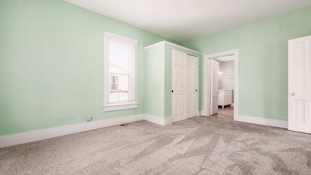 64 W Harrison St, Newark, OH 43055 - unfurnished bedroom with carpet floors, ensuite bath, and a closet