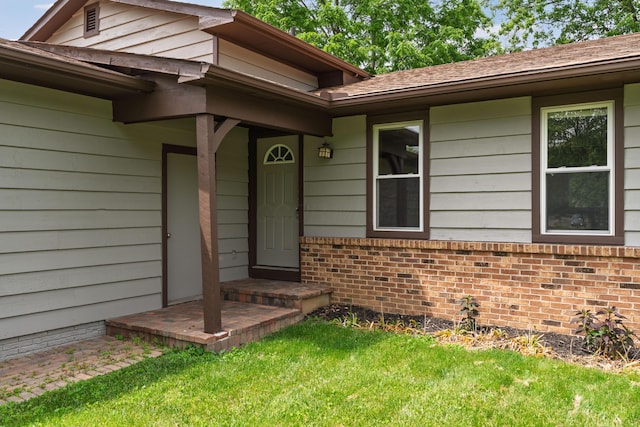 2220 Surreygate Dr, Columbus, OH 43235 - view of exterior entry featuring a lawn and brick siding