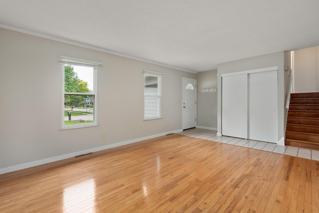 2220 Surreygate Dr, Columbus, OH 43235 - unfurnished living room featuring stairs and light wood-type flooring