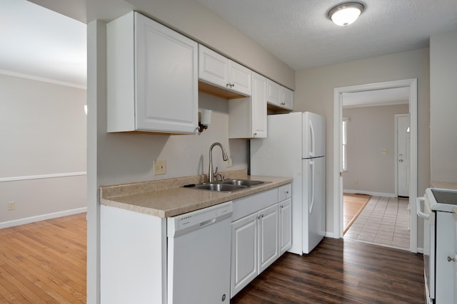 2220 Surreygate Dr, Columbus, OH 43235 - kitchen featuring white appliances, white cabinets, wood finished floors, light countertops, and a textured ceiling