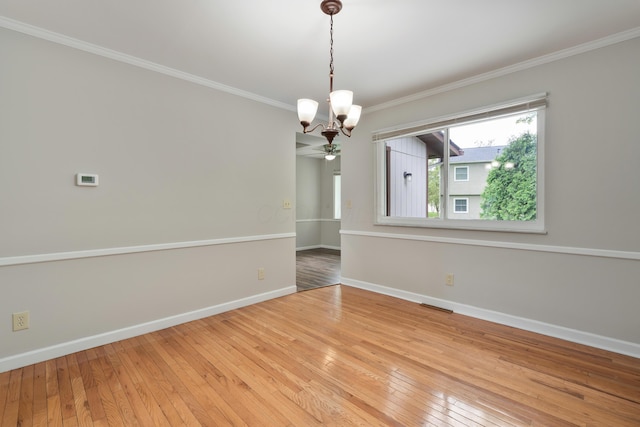 2220 Surreygate Dr, Columbus, OH 43235 - empty room featuring a chandelier, hardwood / wood-style floors, crown molding, and a ceiling fan