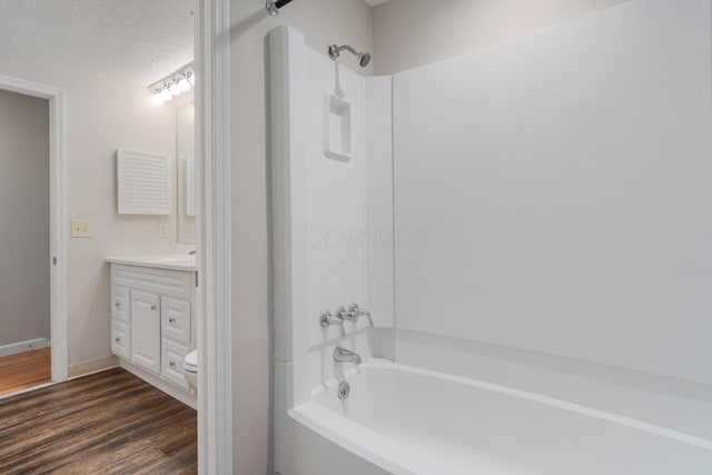 2220 Surreygate Dr, Columbus, OH 43235 - full bathroom with vanity, bathtub / shower combination, wood finished floors, and a textured ceiling