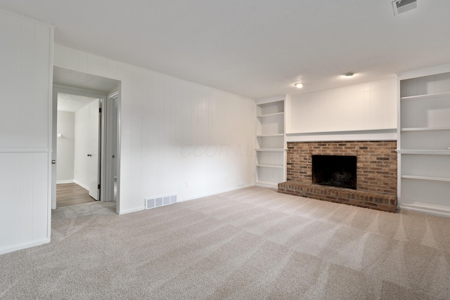 2220 Surreygate Dr, Columbus, OH 43235 - unfurnished living room featuring carpet, a fireplace, and built in shelves