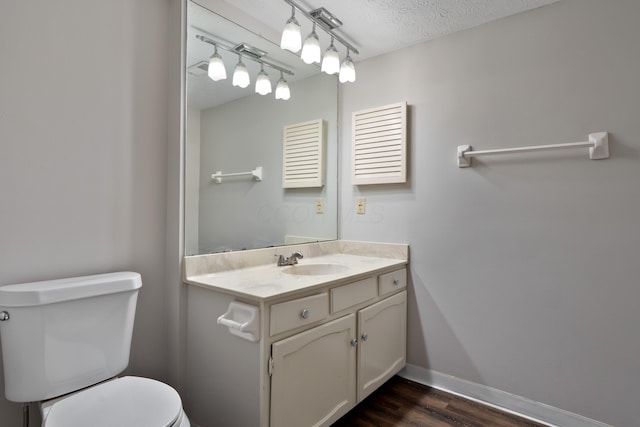 2220 Surreygate Dr, Columbus, OH 43235 - bathroom featuring vanity, track lighting, wood finished floors, and a textured ceiling