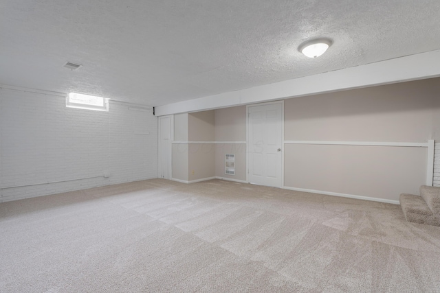 2220 Surreygate Dr, Columbus, OH 43235 - basement featuring brick wall, a textured ceiling, and carpet floors