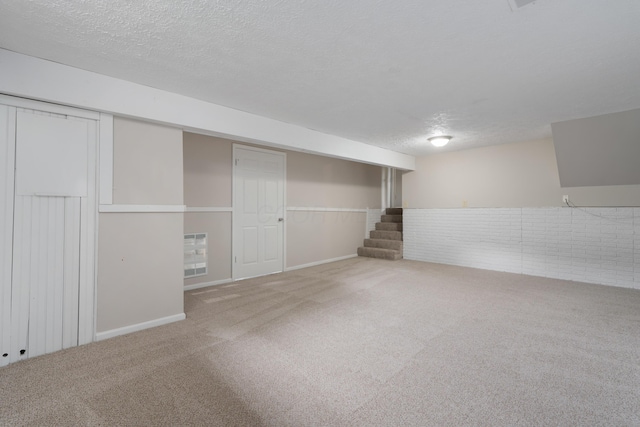 2220 Surreygate Dr, Columbus, OH 43235 - finished below grade area featuring carpet, a textured ceiling, and stairway