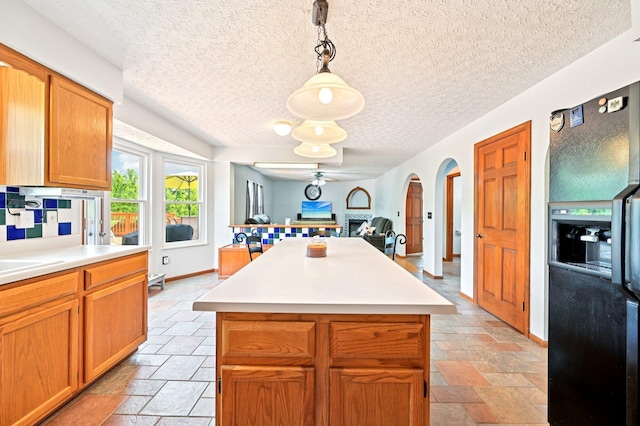5138 Eastbend Dr, Canal Winchester, OH 43110 - kitchen featuring black refrigerator with ice dispenser, stone tile flooring, open floor plan, light countertops, and a textured ceiling