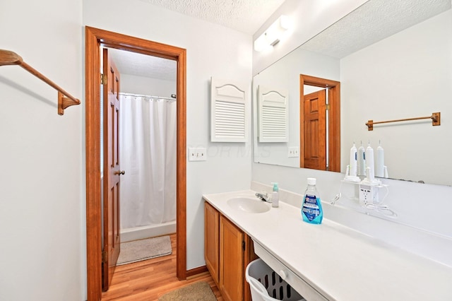 5138 Eastbend Dr, Canal Winchester, OH 43110 - bathroom with a textured ceiling, vanity, wood finished floors, and curtained shower