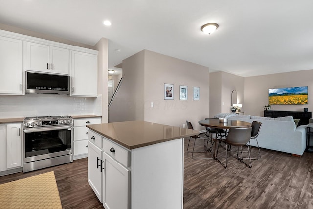 202 Rosewood Loop SW, Commercial Point, OH 43116 - kitchen with appliances with stainless steel finishes, dark wood-style floors, open floor plan, backsplash, and white cabinetry