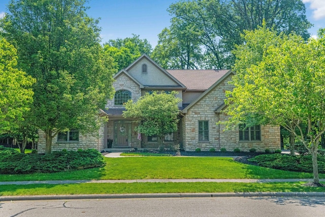 7788 Boylston Ct, Dublin, OH 43016 - view of front facade featuring stone siding, a front lawn, and stucco siding