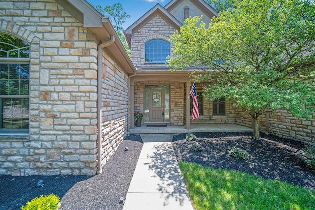 7788 Boylston Ct, Dublin, OH 43016 - doorway to property featuring stone siding and covered porch
