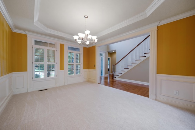 7788 Boylston Ct, Dublin, OH 43016 - carpeted empty room with a chandelier, crown molding, a decorative wall, stairs, and a wainscoted wall
