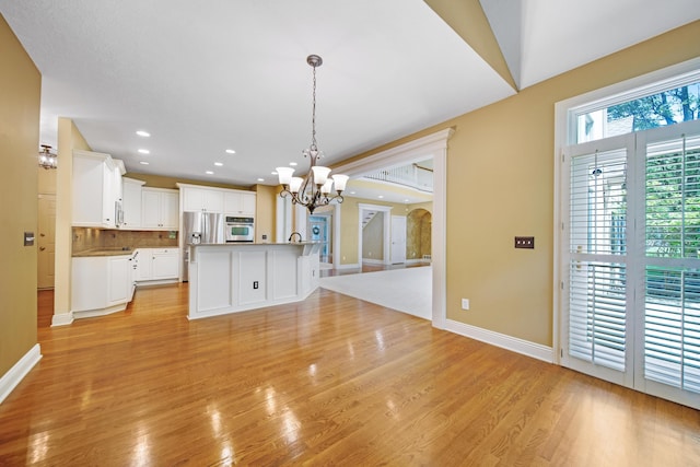 7788 Boylston Ct, Dublin, OH 43016 - kitchen with a chandelier, stainless steel appliances, light wood-style flooring, recessed lighting, and white cabinets