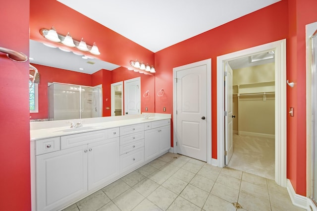 7788 Boylston Ct, Dublin, OH 43016 - full bath featuring a shower stall, double vanity, a walk in closet, and tile patterned flooring