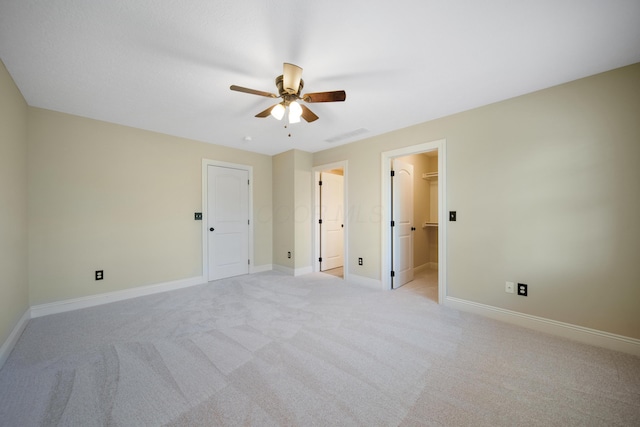 7788 Boylston Ct, Dublin, OH 43016 - unfurnished bedroom featuring light colored carpet, a walk in closet, and ceiling fan