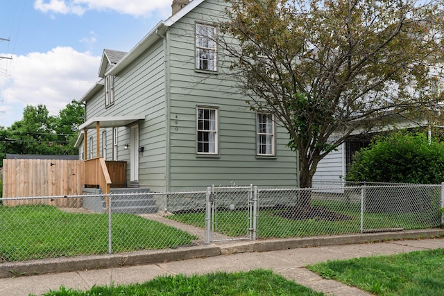 490 E Mithoff St, Columbus, OH 43206 - view of home's exterior featuring a gate and a chimney