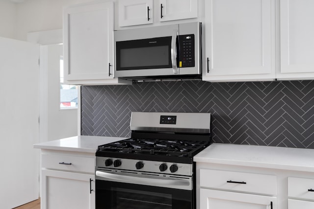 490 E Mithoff St, Columbus, OH 43206 - kitchen with stainless steel appliances, tasteful backsplash, light countertops, and white cabinets