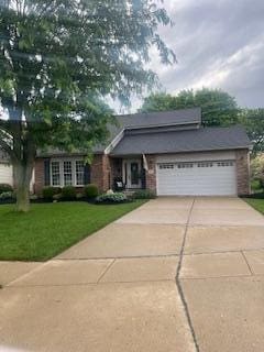 2715 Field Post Ct, Hilliard, OH 43026 - view of front of home with a front lawn, concrete driveway, an attached garage, and brick siding
