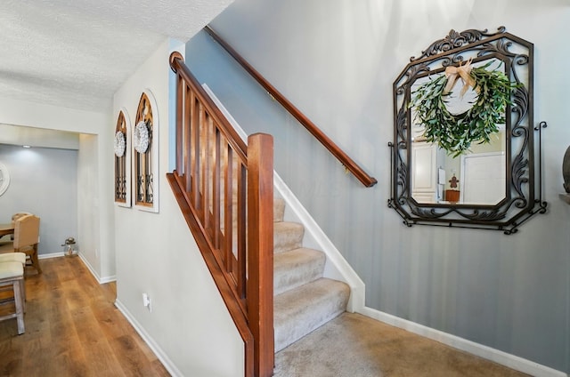6235 Hampton Green Pl Unit 5B, Dublin, OH 43016 - staircase featuring wood finished floors and a textured ceiling