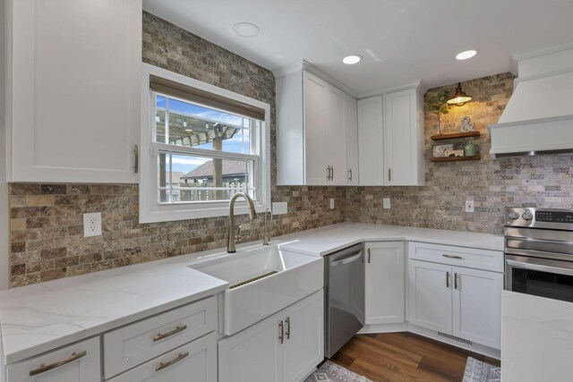 1859 State Route 257 N, Ostrander, OH 43061 - kitchen with appliances with stainless steel finishes, backsplash, white cabinetry, custom exhaust hood, and light stone counters