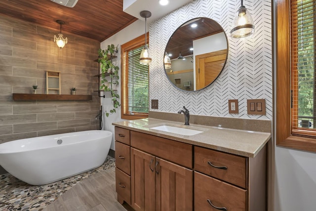 1859 State Route 257 N, Ostrander, OH 43061 - bathroom with a freestanding tub, vanity, plenty of natural light, tile walls, and wooden ceiling