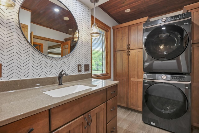 1859 State Route 257 N, Ostrander, OH 43061 - laundry area with stacked washer / dryer, cabinet space, light wood-style flooring, and wood ceiling