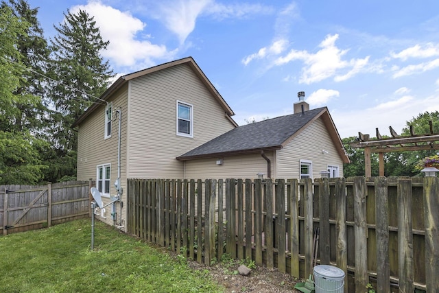 1859 State Route 257 N, Ostrander, OH 43061 - view of home's exterior with a fenced backyard, roof with shingles, and a chimney