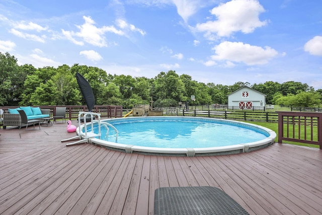 1859 State Route 257 N, Ostrander, OH 43061 - view of pool with a wooden deck, an outdoor living space, an outbuilding, and view of scattered trees