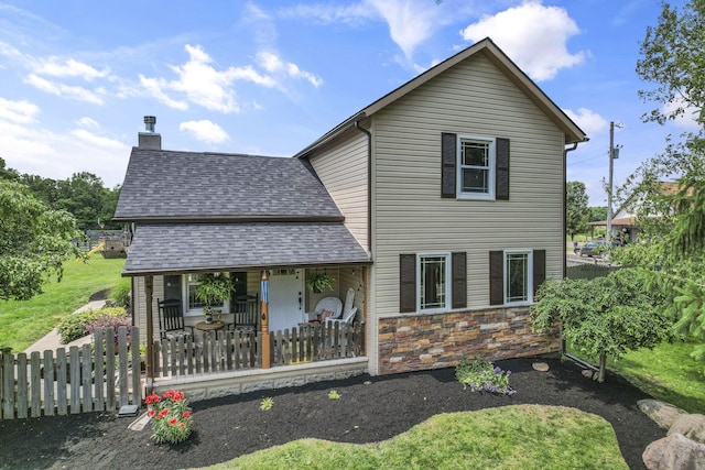 1859 State Route 257 N, Ostrander, OH 43061 - view of front of property with covered porch, a chimney, a shingled roof, and stone siding