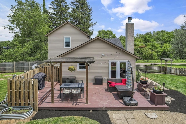 1859 State Route 257 N, Ostrander, OH 43061 - back of house with a wooden deck, a fenced backyard, an outdoor living space, a chimney, and outdoor dining area