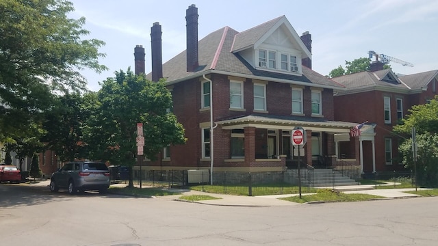 65 Warren St Unit 1/2, Columbus, OH 43215 - view of front of house featuring a chimney, brick siding, and covered porch