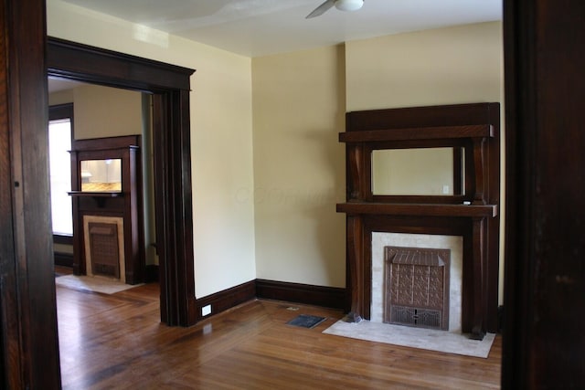 65 Warren St Unit 1/2, Columbus, OH 43215 - unfurnished living room featuring wood finished floors, a ceiling fan, baseboards, and a fireplace with flush hearth