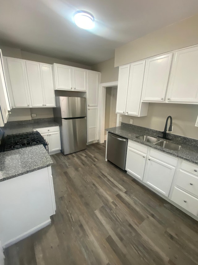 384 E 17th Ave, Columbus, OH 43201 - kitchen with appliances with stainless steel finishes, a sink, white cabinetry, and dark wood-style flooring
