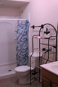 384 E 17th Ave, Columbus, OH 43201 - full bath featuring a stall shower, toilet, vanity, and tile patterned flooring