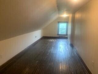 384 E 17th Ave, Columbus, OH 43201 - additional living space featuring dark wood finished floors, vaulted ceiling, and baseboards
