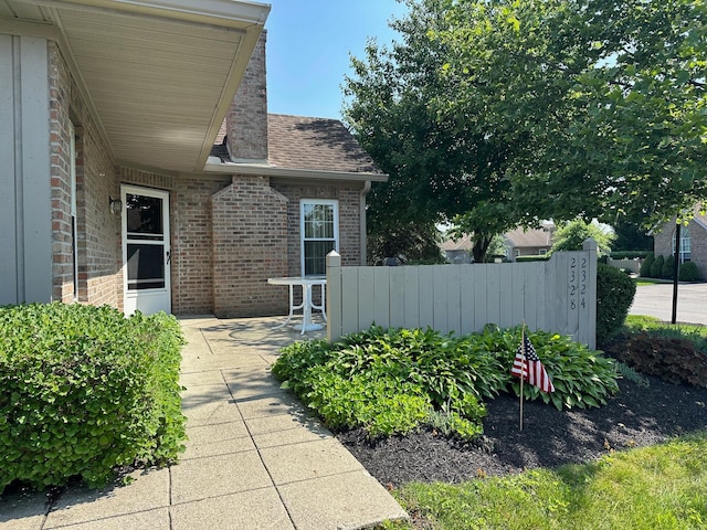 2328 Willowside Ln, Grove City, OH 43123 - doorway to property featuring brick siding, a patio, and a shingled roof