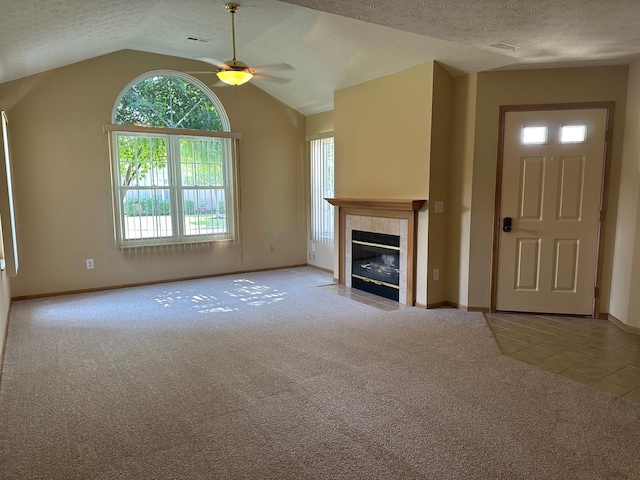 2328 Willowside Ln, Grove City, OH 43123 - unfurnished living room featuring carpet, a ceiling fan, a textured ceiling, a fireplace, and lofted ceiling