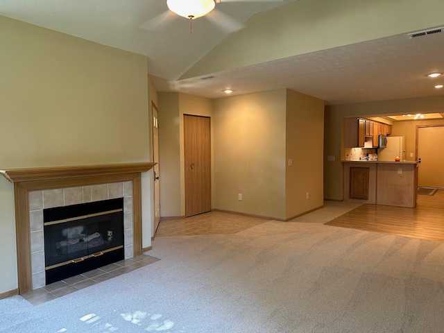2328 Willowside Ln, Grove City, OH 43123 - unfurnished living room featuring light carpet, ceiling fan, a fireplace, recessed lighting, and vaulted ceiling