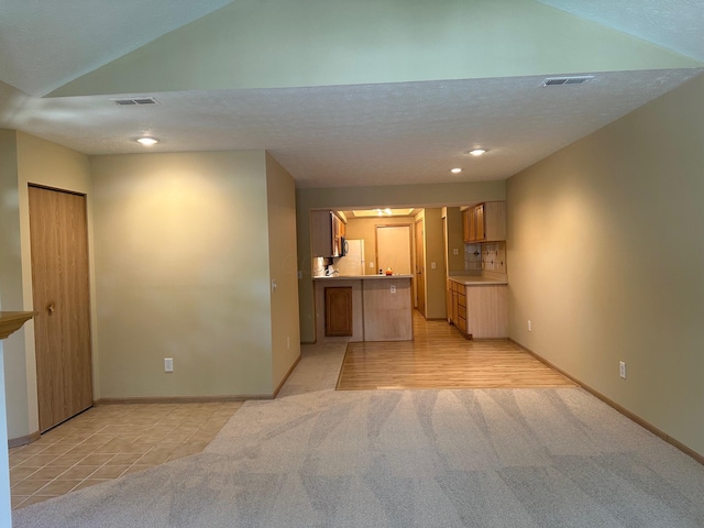 2328 Willowside Ln, Grove City, OH 43123 - unfurnished living room with vaulted ceiling, light colored carpet, and recessed lighting