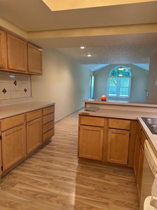 2328 Willowside Ln, Grove City, OH 43123 - kitchen featuring dishwasher, light wood-type flooring, light countertops, decorative backsplash, and vaulted ceiling