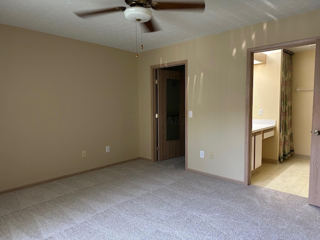2328 Willowside Ln, Grove City, OH 43123 - unfurnished bedroom featuring light colored carpet, ensuite bathroom, a textured ceiling, and a ceiling fan