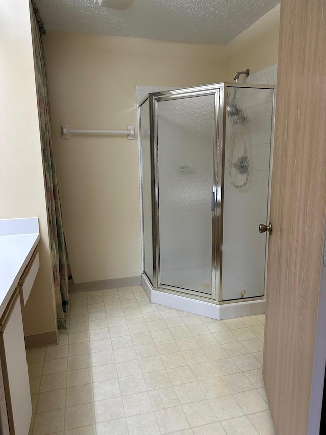 2328 Willowside Ln, Grove City, OH 43123 - full bathroom with a shower stall, vanity, and a textured ceiling