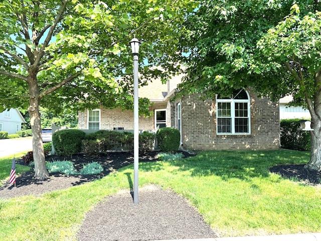 2328 Willowside Ln, Grove City, OH 43123 - obstructed view of property with brick siding and a front lawn