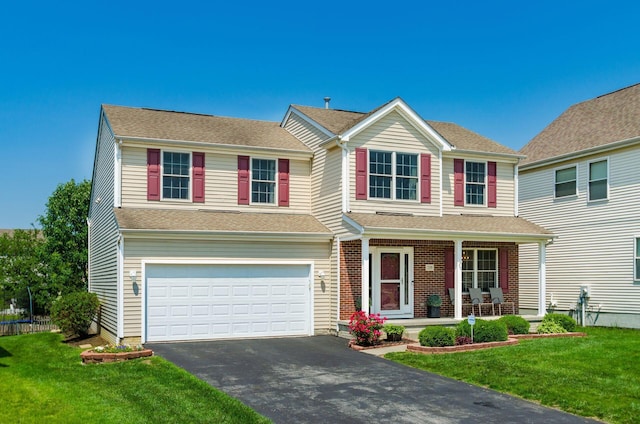 729 Lilly Landing Ln, Blacklick, OH 43004 - view of front of home featuring a porch, asphalt driveway, a garage, and a front yard