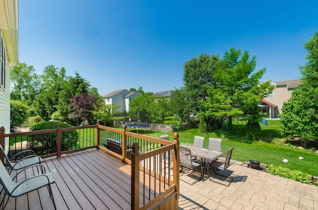 729 Lilly Landing Ln, Blacklick, OH 43004 - wooden deck featuring a trampoline, outdoor dining area, a patio area, and a fenced backyard