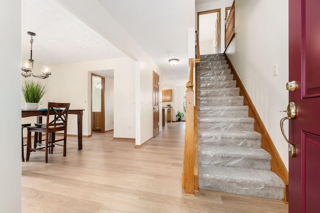 1553 Grove Hill Dr, Columbus, OH 43240 - entryway featuring stairs, light wood-style flooring, and a chandelier