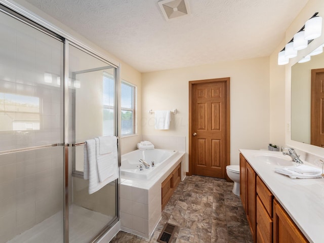 1553 Grove Hill Dr, Columbus, OH 43240 - bathroom featuring a garden tub, vanity, a stall shower, stone finish floors, and a textured ceiling